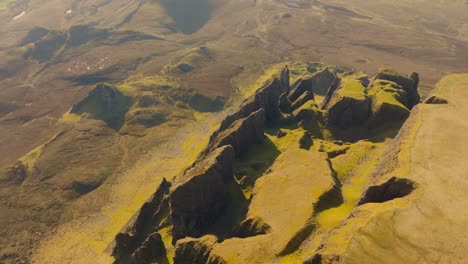 aerial drone footage of the dramatic mountain landscapes on the isle of skye, scotland. sweeping panoramic views of majestic peaks, green valleys, and wild nature. quiraing walk