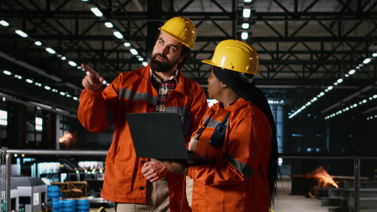 Diverse engineers, using walkie-talkie, portable transceiver, heavy industry