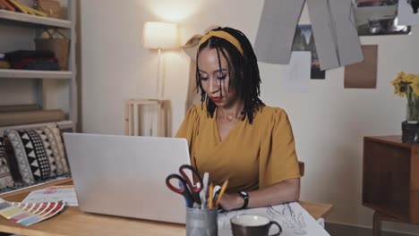 female fashion designer working on laptop