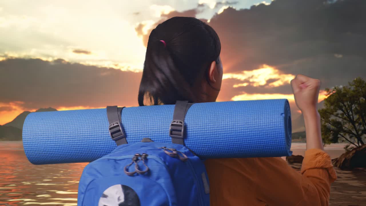 Close Up Back View Of A Female Hiker With Mountaineering Backpack Screaming Goal Celebrating The Success While Standing At A Lake During Sunset Time