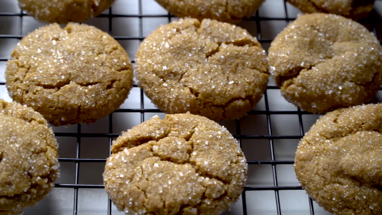 Tempting homemade ginger cookies on cooling rack, close up movement