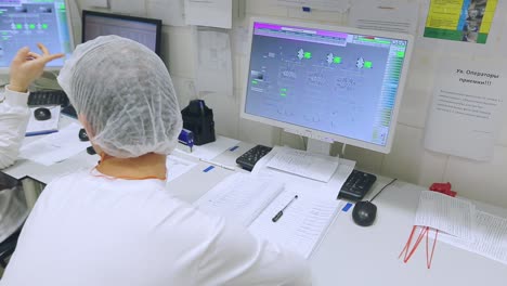 factory employee working on computer. control center monitor