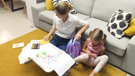 mother and daughter doing homework at home