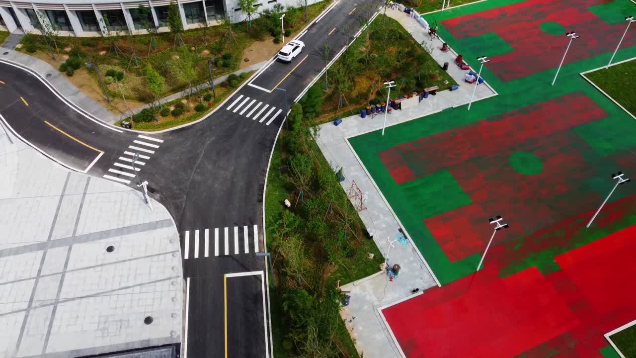 Aerial drone rotating dolly view of an outdoor car park in a modern olympic sports complex in China