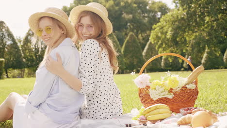 two friends enjoying a picnic in the park