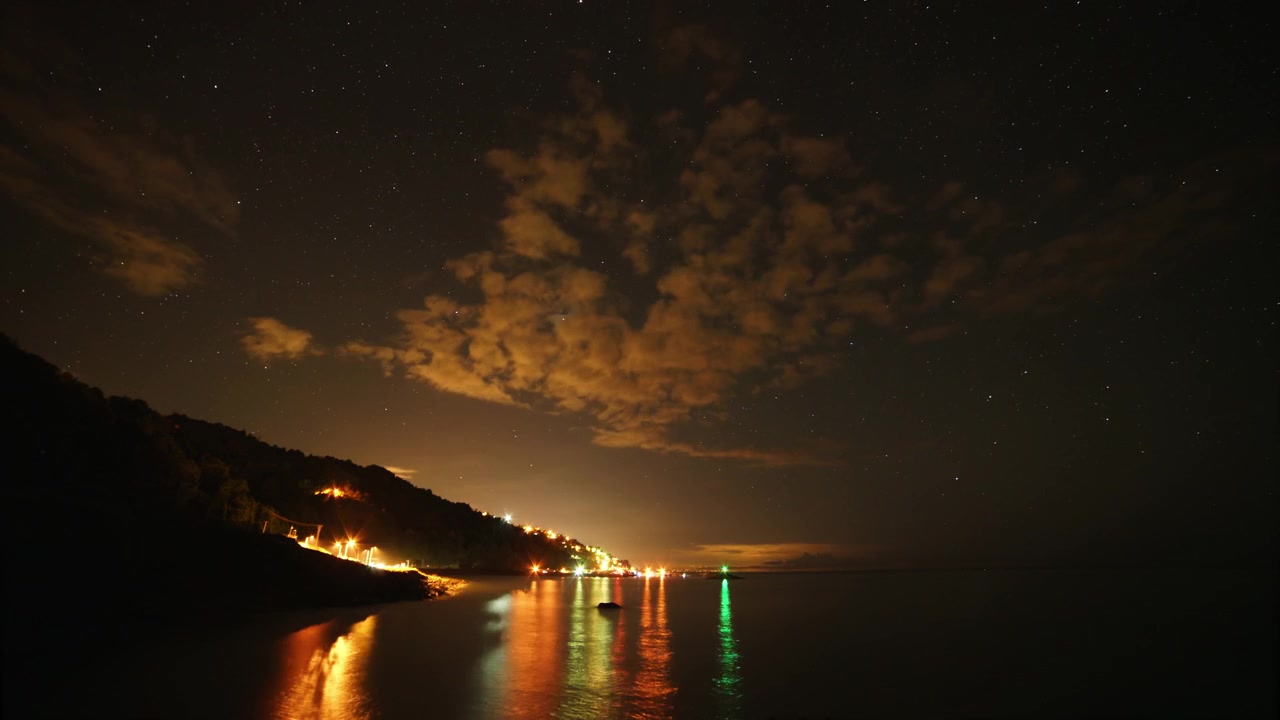 Time Lapse of Starry Night Sky Over Coastal Town