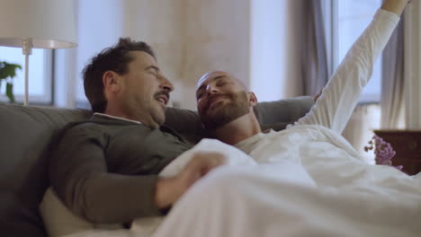 happy homosexual men waking up in morning
