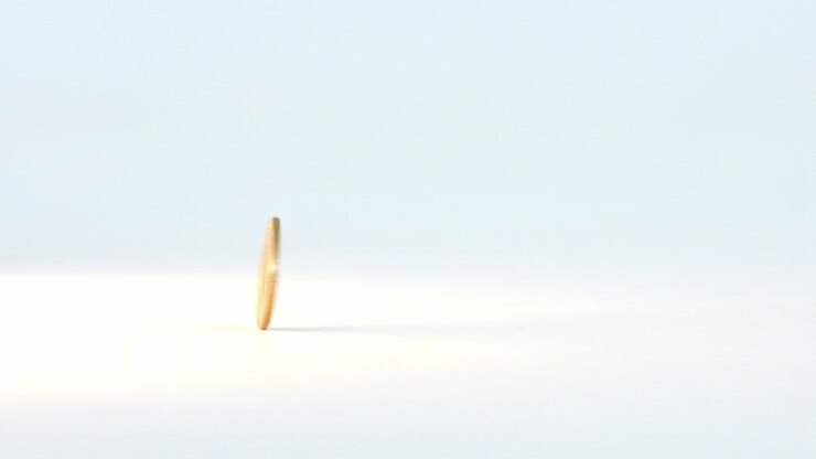 One hryvnia coin rotates on a white background