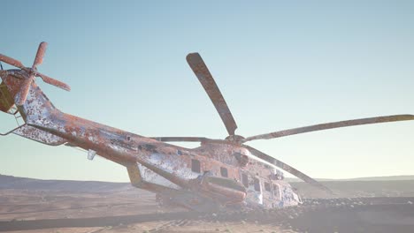 old-rusted-military-helicopter-in-the-desert-at-sunset