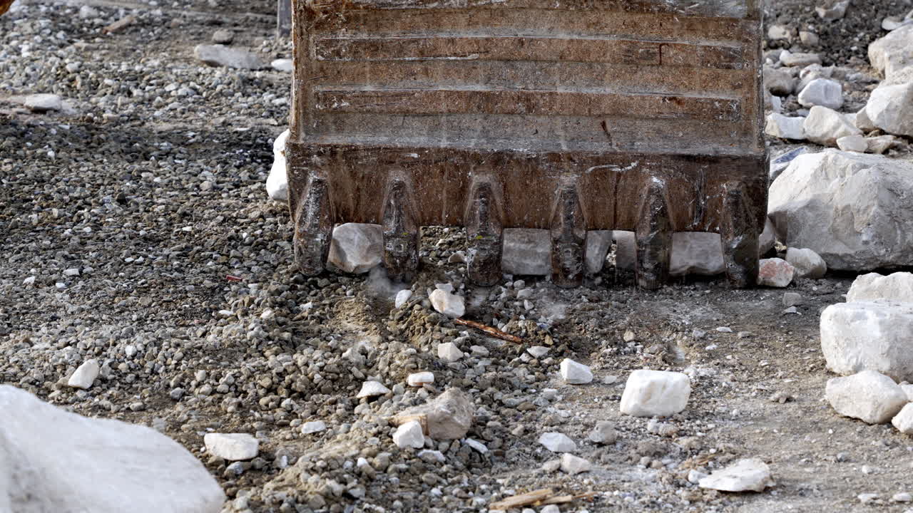 Bulldozer moving rocks on a construction site, dusty and rugged setting