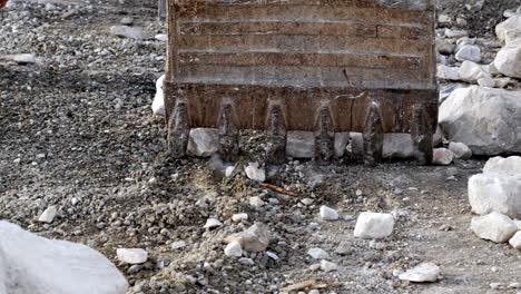bulldozer moving rocks on a construction site, dusty and rugged setting