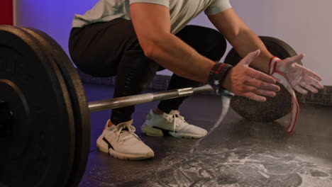 sportswoman preparing to lift barbell