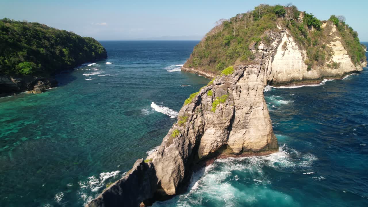 Flying Along Steep Cliffs of Nusa Batupadasan Island In Front of Nusa Penida's Atuh Beach in Indonesia