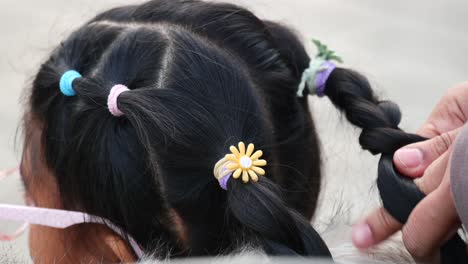 child's pigtails with colorful hair ties