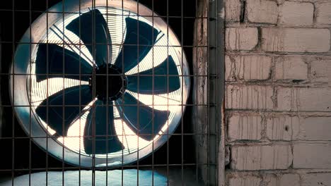 big industrial fan in a white brick wall of a factory. ventilation of factory building. video background with copy space