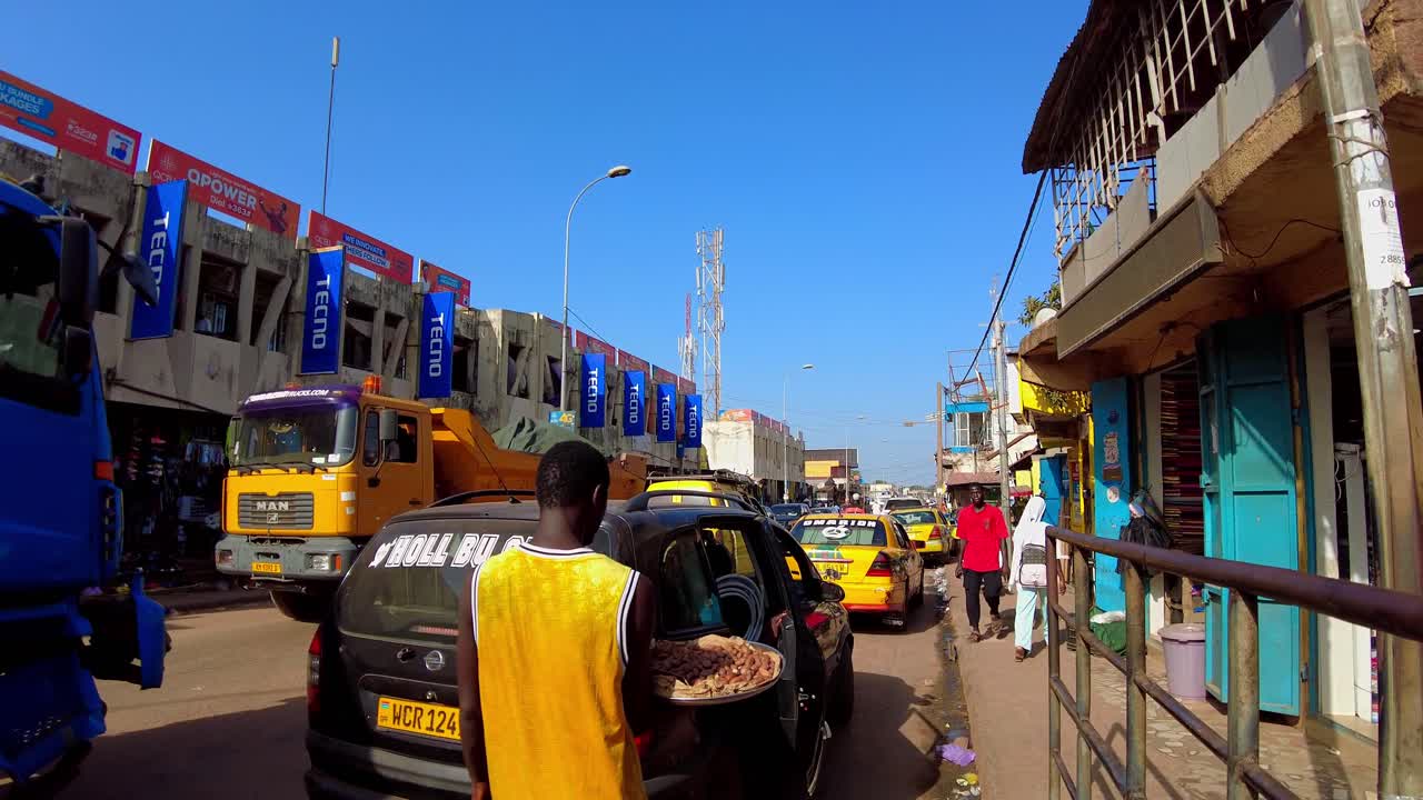 Panoramic at Busy Serekunda Streets, African open air market, people and traffic at daylight
