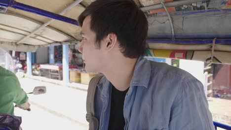 man in a thai songthaew