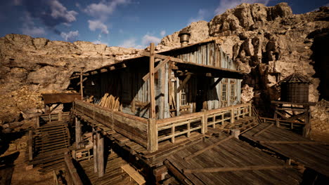 a wooden shack in the middle of a desert canyon