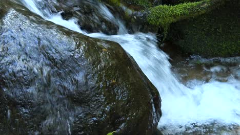 close up of water running away part of a waterfall