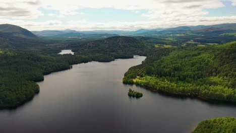 Aviemore's-Ancient-Canopy:-Aerial-Overlook-of-Loch-An-Eilein-Surrounded-by-Scots-Pine-Forest,-Cairngorms,-Scottish-Highlands,-Scotland