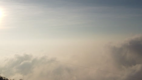 Beautiful-sunrise-timelapse-taken-at-a-high-altitude-above-clouds-in-the-mountains-above-Kodaikanal,-Tamil-Nadu