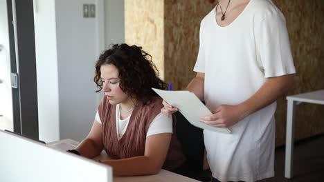 focused colleagues working with documents in office