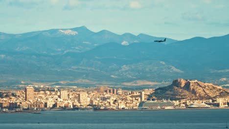 view of a city from across a body of water taken from the santa pola cliffs