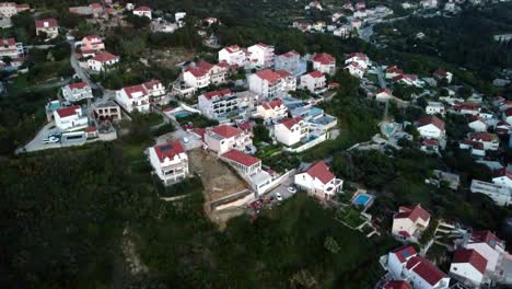 Aerial-footage-over-some-houses-and-apartments-on-the-coast-of-Croatia-in-Mlini-the-mountains-side-town