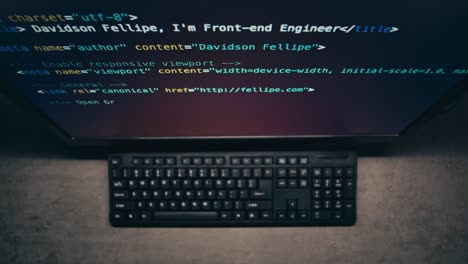 computer screen showing code and keyboard