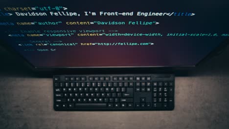 computer screen showing code and keyboard