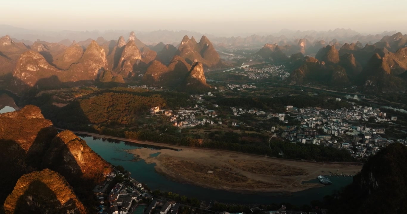 Il tramonto dorato illumina il fiume Li e il vasto paesaggio carsico di Yangshuo.