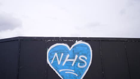 Street-art-and-graffiti-of-a-blue-heart-for-the-NHS-in-London-United-Kingdom,-support-to-the-national-health-service-during-Covid-19-Coronavirus-pandemic