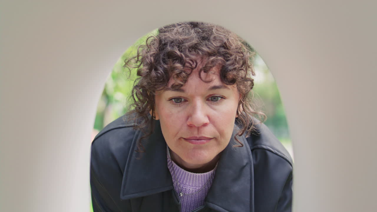 Woman Examining Empty Mailbox and Sighing with Disappointment