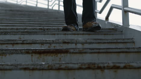 man going downstairs on a bridge