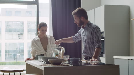 Pareja-Feliz-Bebiendo-Agua-En-Una-Cocina-Moderna