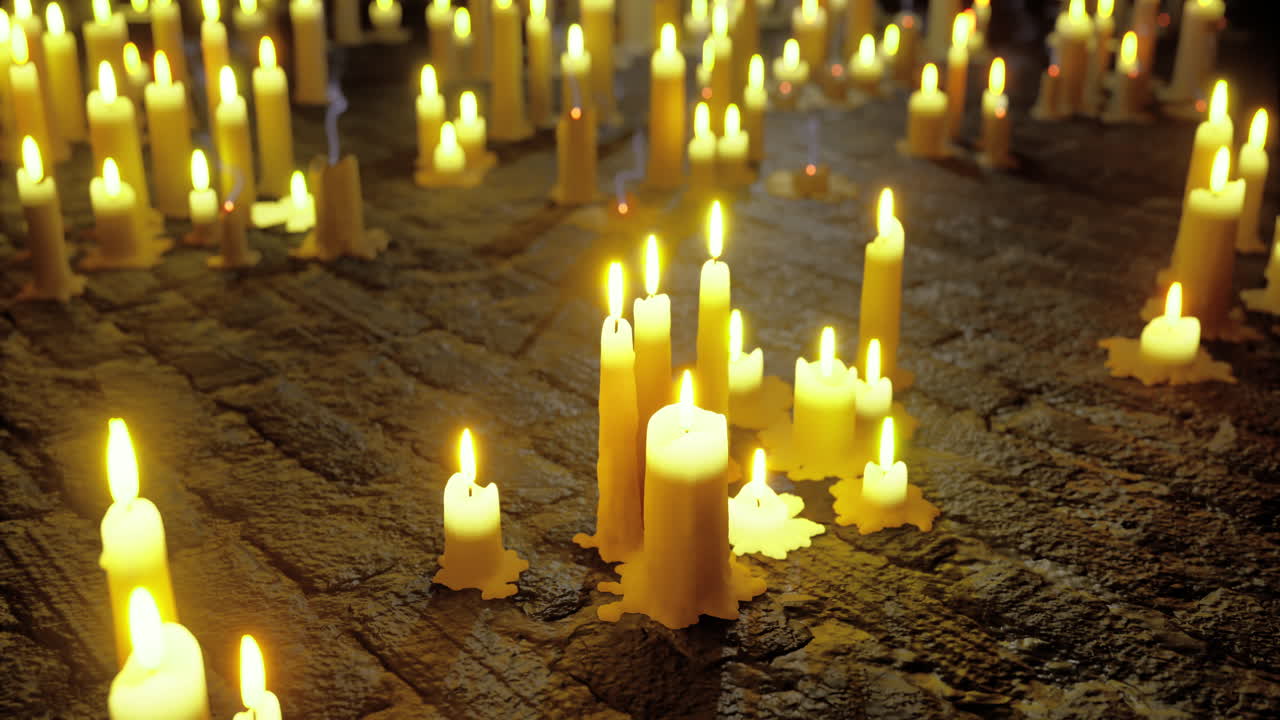 Warm glow of candles illuminating a dark rustic space at night