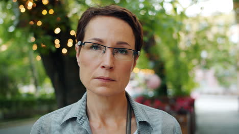 woman wearing glasses in a park