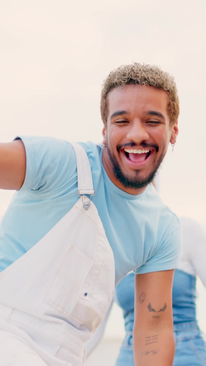 Latin man smiling and dancing freestyle outdoors