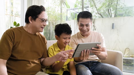 asian men and boy in the living room