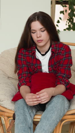 woman moves fingers sitting in armchair. sad lady disappointed because of last unpleasant conversation with best friend. feeling of being worthless