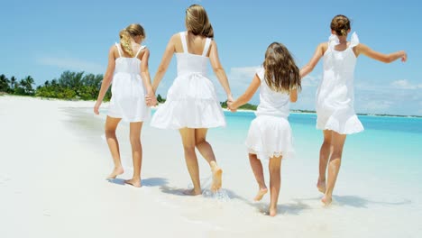 caucasian girls with their mother enjoying beach vacation