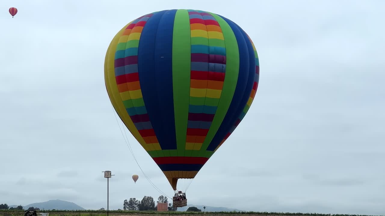 Colorful Hot air balloon taking off on Cloudy day, static shot