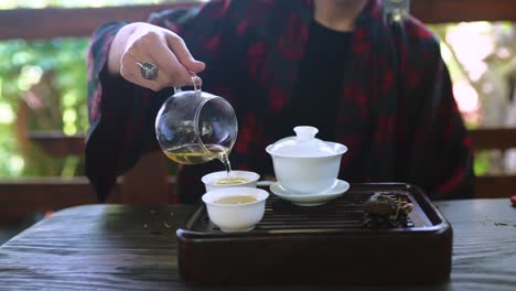 woman pouring tea during a traditional tea ceremony