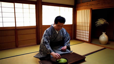 man preparing matcha tea in traditional japanese room