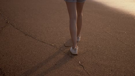 woman walking on a private beach at sunset