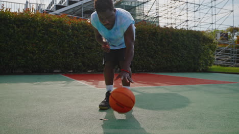 man dribbling basketball on outdoor court