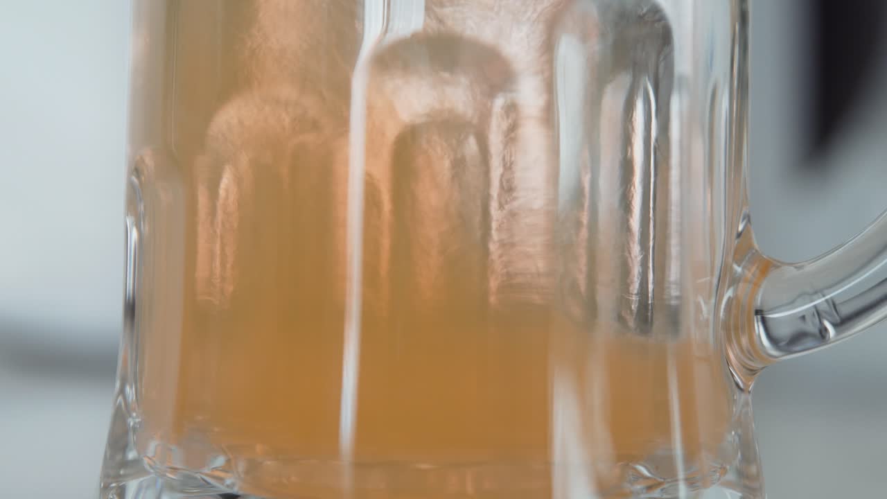 Effervescent orange tablet falling on a glass of water