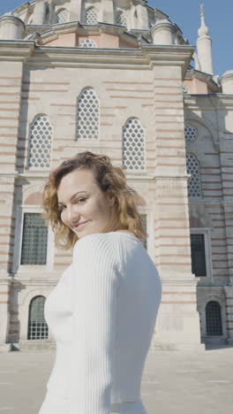 woman in front of a mosque