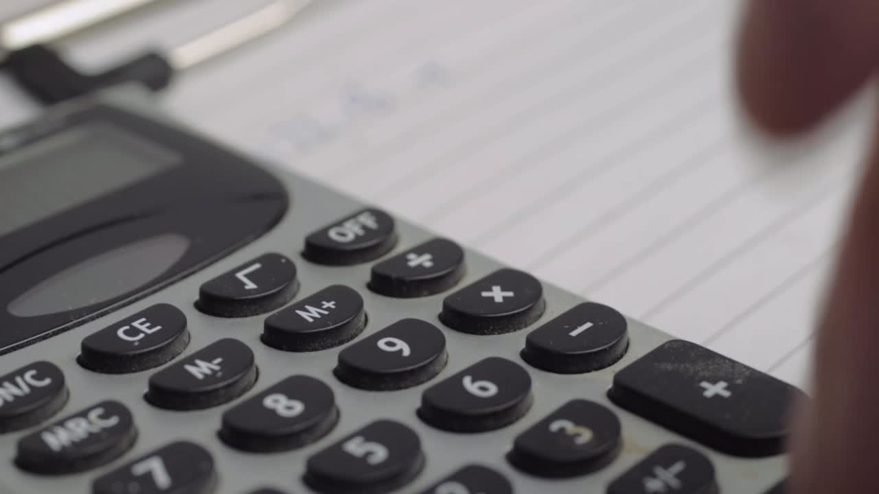 Hand using a calculator close up shot