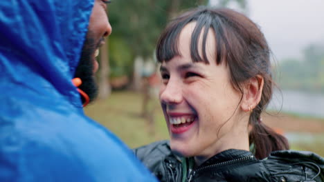 hiking, travel and a couple hugging in the rain